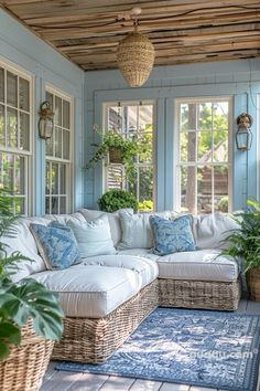 a living room filled with lots of furniture and plants