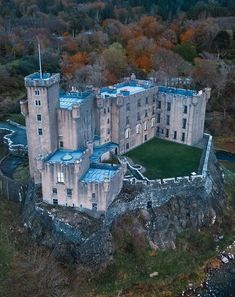 an aerial view of a castle in the woods