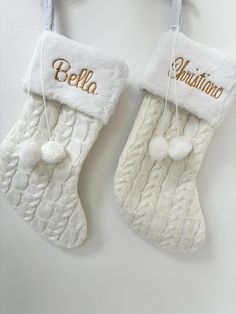 two white christmas stockings hanging on a wall