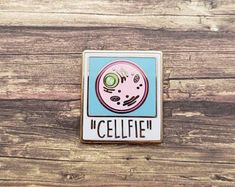 a pin with an image of a cell phone on it