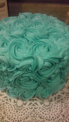 there is a cake with blue frosting on the top and swirls in the middle