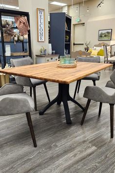 a table with six chairs around it in a room that has furniture on the floor