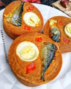 three fried fish in bread on a white plate