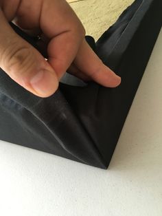 a hand that is touching the side of a bag