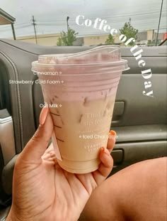 a woman holding up a cup of coffee in the back seat of a car with information about it