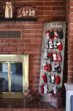 a fireplace with stockings hanging on it and a christmas stocking calendar next to it