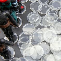 plastic cups with toy soldiers on them sitting next to each other