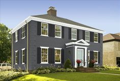 a blue house with black shutters and white trim