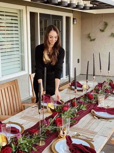 the woman is setting the table outside for dinner