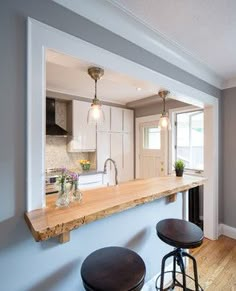 a kitchen with an island counter top and bar stools