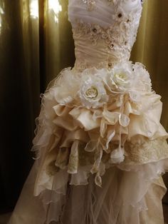 a wedding dress with flowers on the skirt