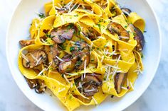 a white bowl filled with pasta and mushrooms