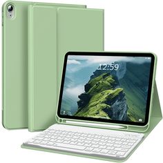 an open laptop computer sitting on top of a white table next to a green tablet