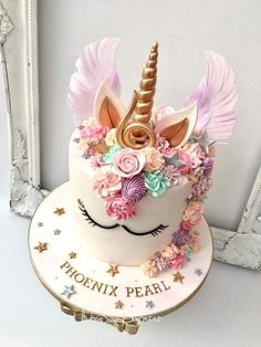 there is a cake decorated with flowers and a unicorn's head