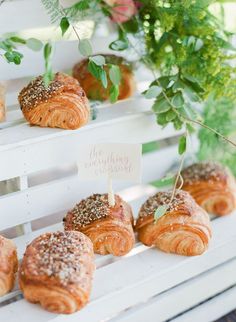 some croissants are sitting on a white shelf