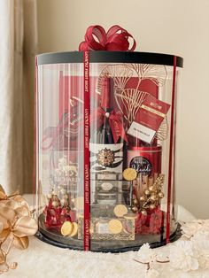 a large gift box filled with lots of red and gold items sitting on top of a table