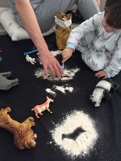 two children are playing with toys on the floor