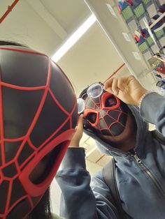 a person wearing a spider man mask and goggles