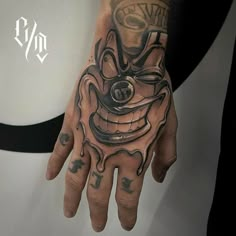 a man's hand with a tattoo on it