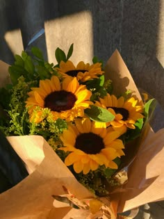 a bouquet of sunflowers sitting on top of a wooden table