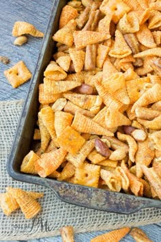 a pan filled with cheetos sitting on top of a table