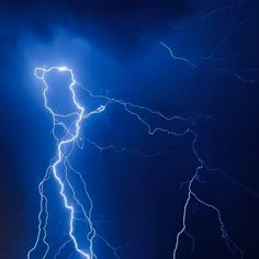 lightning strikes in the night sky over a city