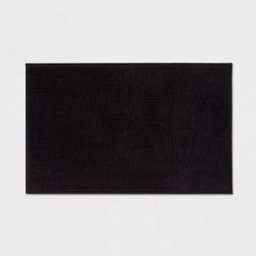 a black piece of cloth on a white surface