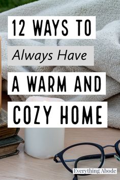 an open book, cup and glasses on a table with text overlay that reads 12 ways to always have a warm and cozy home