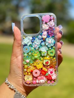 a person holding up a phone case with buttons on it