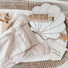 a wicker basket filled with baby items including an umbrella, booties and other accessories