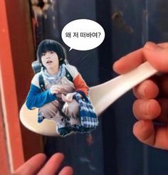 a person holding a spoon with a picture on it