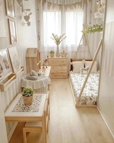 a room with two beds, tables and pictures on the wall