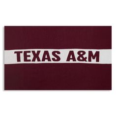 the texas a & m logo on a maroon and white towel