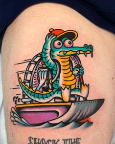 a man with a tattoo on his thigh that says, shock the boat and an image of a sea horse