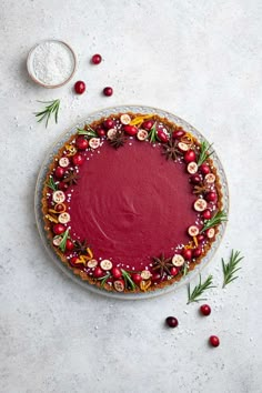 a tart with cranberry sauce and sprinkles on top, surrounded by other ingredients