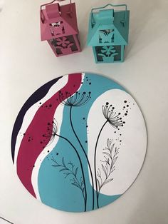 two paper boxes sitting on top of a table next to a flowered plate and candle holder