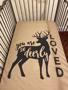 a baby crib with a blanket that says you are so deery