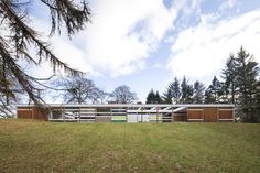 the house is surrounded by trees and grass