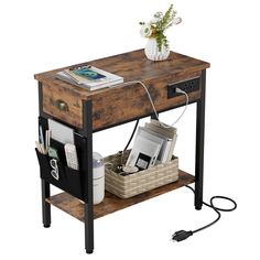 a wooden table with a phone charging station on the top and a basket under it