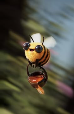 a toy bee with sunglasses on its head is flying through the air and looking at something