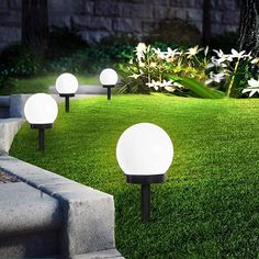 several white lights sitting on top of green grass