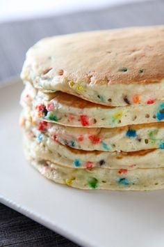 a stack of pancakes with sprinkles on a plate