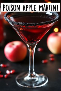 a close up of a drink in a glass on a table with apples and confetti