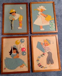 four framed children's pictures are shown on the floor, with one child holding balloons