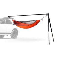 an orange hammock attached to the back of a white truck on a white background