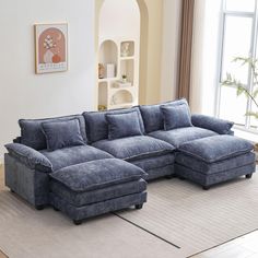 a living room with a large blue sectional couch