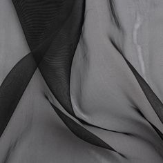 black and white photograph of sheer fabric with wavy lines on the bottom half of it