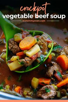 a spoon full of vegetable beef soup with carrots and celery