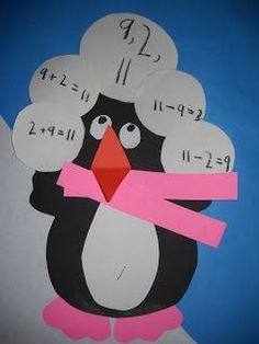 a paper cut out of a penguin with numbers on it