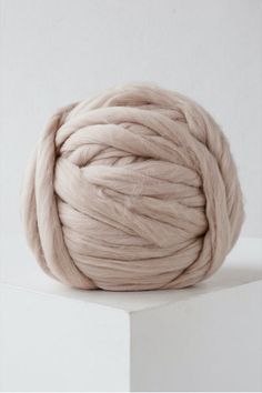 a ball of yarn sitting on top of a white block